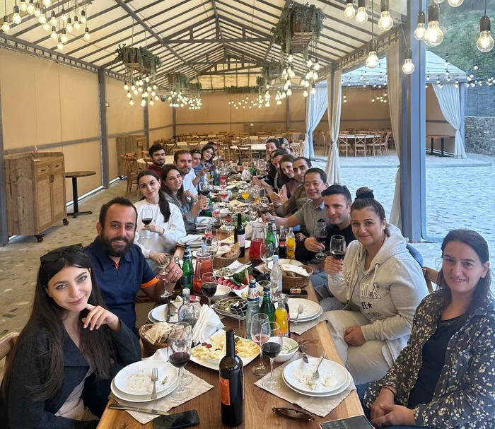 A team lunch under a glass roof
